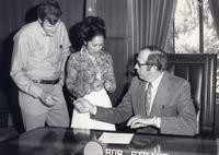 Patricia Whiting receiving pen from governor