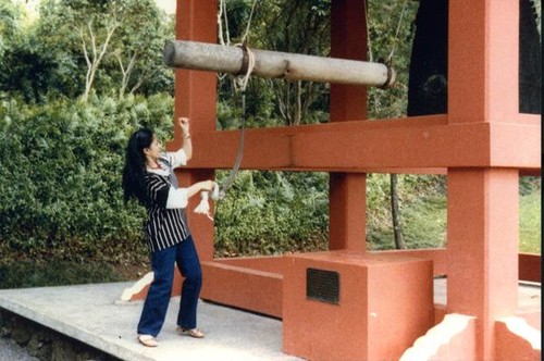 Patricia Whiting ringing the temple bells
