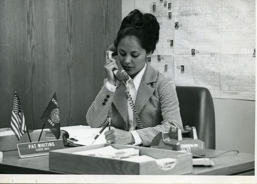 Patricia Whiting taking phone call at her desk