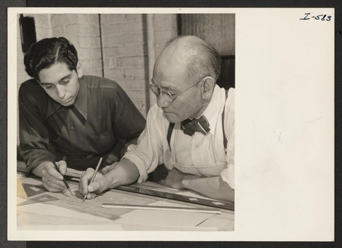 Mr. Soichi Yamamoto, formerly of Pasadena, California, and Gila River, is shown here with a fellow employee doing mechanical design
