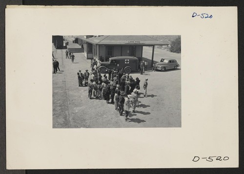 Manzanar, Calif.--Evacuees of Japanese ancestry await bus for Manzanar, War Relocation Authority center, where they will spend the duration. They were brought by train to Lone Pine from Elk Grove, California. Photographer: Stewart, Francis Manzanar, California