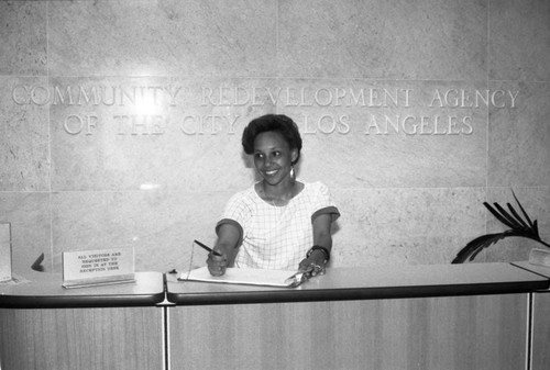 Community Redevelopment Agency staff standing at the reception desk, Los Angeles