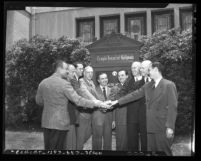 Nine men posing in front of Temple Israel of Hollywood in 1946