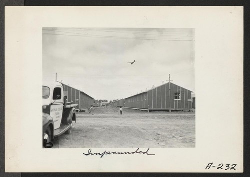 Looking between two rows of barracks at the Salinas Assembly Center. Photographer: Albers, Clem Salinas, California