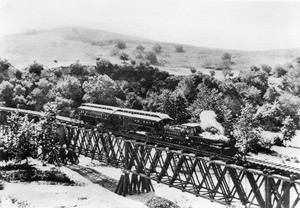 Los Angeles and San Gabriel Railroad train on the bridge at Garvanza, the first trestle across the Arroyo Seco, approaching Highland Park from South Pasadena, ca.1885