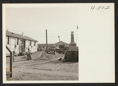Children play in the barracks area of the Winona Housing Project at Burbank, California, where returned evacuees find temporary quarters while locating permanent homes in the Los Angeles area. Photographer: Mace, Charles E. Burbank, California