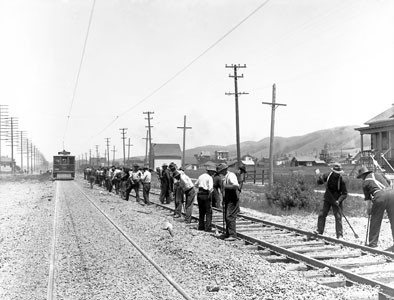 Men working on Oakland to Albany street car tracks