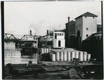 [Cargo barge and steamboats moored along Sacramento waterfront]