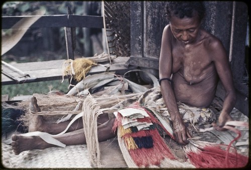 Weaving: woman makes multi-layer, dyed skirt from banana and pandanus-leaf fibers, she sits on mat of woven pandanus leaves