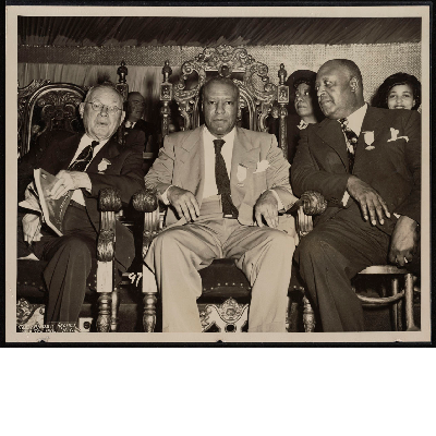 Ralph Bunche, A. Philip Randolph, and Milton P. Webster sitting in chairs