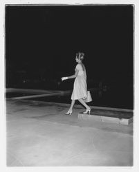 Backless evening dress modeled at the Sword of Hope fashion show at the Flamingo Hotel, Santa Rosa, California, 1960