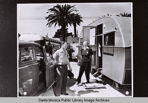 Couple outside trailer home in Santa Monica, part of the Douglas Aircraft Company employee housing during World War II