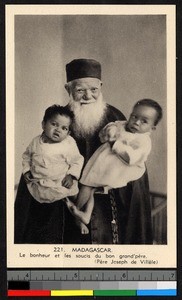 Missionary father holding two infants on his lap, Madagascar, ca.1920-1940
