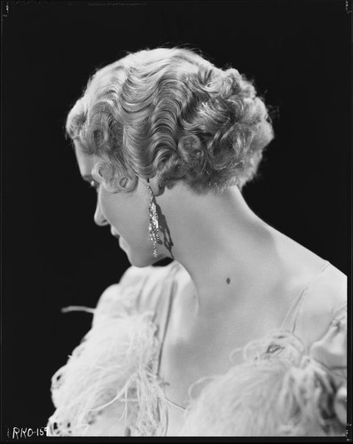Peggy Hamilton modeling a hairstyle and evening gown, circa 1933