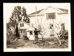 J. B. Keil Pruning Trees back of Greenhouse