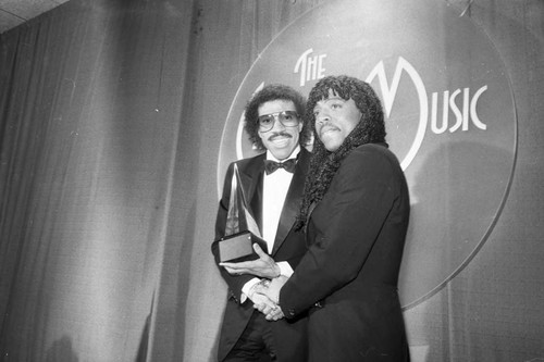 Rick James posing with Lionel Richie at the American Music Awards, Los Angeles, 1983