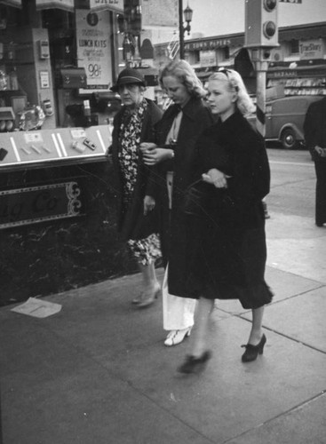Three women in front of drug store