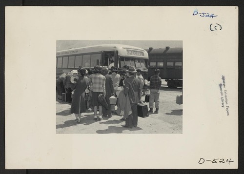Lone Pine, Calif.--Evacuees from Sacramento to change from the train to a bus on their trip to the Manzanar War Relocation Authority center where they will spend the duration. Photographer: Stewart, Francis Manzanar, California