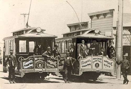 [Employees of the San Francisco & San Mateo Electric Railway Company posing with two streetcars]