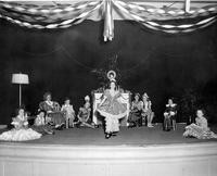 Costumed children performing on stage