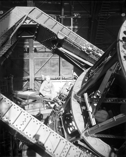 Francis Pease seated at the cassegrain focus of the 100-inch telescope, Mount Wilson Observatory