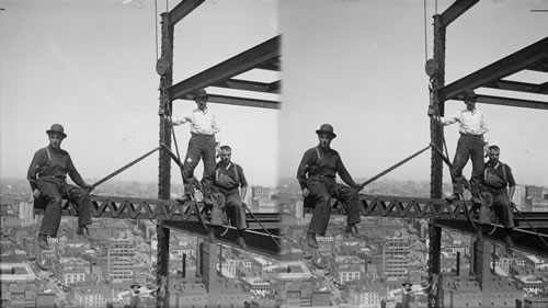 Agile construction men - on a suspended iron section 200 ft. above ground. New York