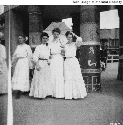Three women posing inside the Science of Man Building at the 1915 Exposition