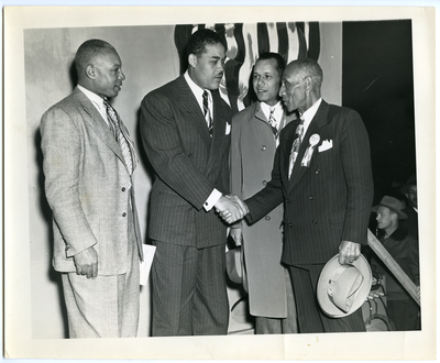 Boxer Joe Louis and Frederick M. Roberts shaking hands
