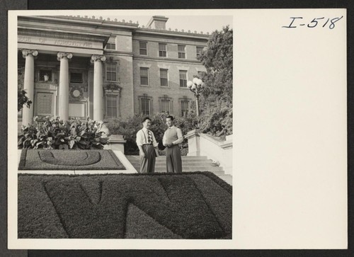 Keith Nakamura and Toru Iura are shown at the entrance to the College of Agriculture building at the University of