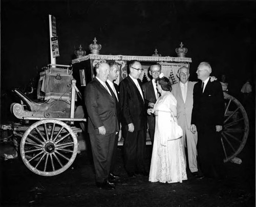 Christine Sterling with Earnest Debs, Roy Ball, Chief Barker, Judge Brown, John Anson Ford, and Judge Faries in front of a coach
