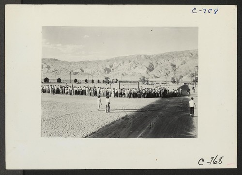 Manzanar, Calif.--Evacuees watching a baseball game at this War Relocation Authority center. This is a very popular recreation with 80
