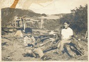 Rose Wiley and brother Del Trujillo sitting on a woodpile at Trujillo Ranch, Topanga, California