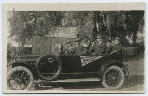 Automobile passengers with "On the boundary line U.S. & Mexico" pennant