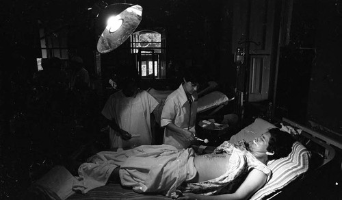 Hospital workers treat an injured man, Nicaragua, 1979