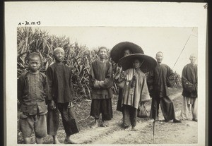 Chinese people and two nuns (wearing hats)