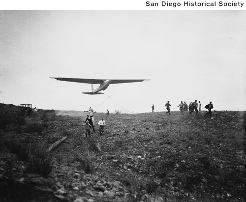 People following a glider as it takes off