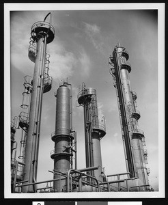 Exterior view of the Shell Oil Company, showing four cylindrical towers, ca.1940