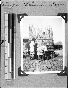 Men building a hut for storage, Nyasa, Tanzania, 1937