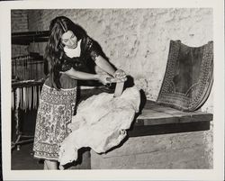 Linda Margarain performs many chores at the Petaluma Adobe, including spinning, grinding corn, candlemaking, baking, etc, Petaluma, California, 1977