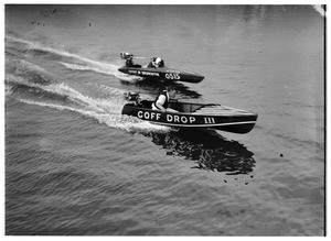 Man in a motorboat which bears the name "Coff Drop" racing with the "Spirit of Bronchitis" boat at the Los Angeles Harbor, ca.1928