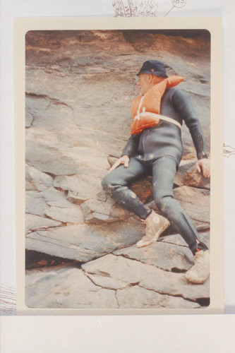 Dock Marston posed at the 1836 D. Julien inscription in Cataract Canyon--Mile 185.75 [should the year be 1964?]