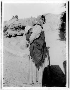 Chemehuevi Indian woman carrying a papoose on her back, ca.1900