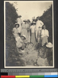 Missionaries standing along a rocky hiking trail, Shantou, Guangdong, China, 1919