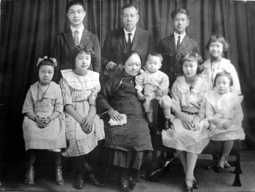 Rose Wong in family portrait--Rose Wong is frist from right, standing. Back Row: Lee Ying Middle Row (left to right): Harry, Mr. Lee, Charles, and Bertha Front Row: Helen, Lily, Mrs. Lee (Aileen), Tommy, Rose, and Florence