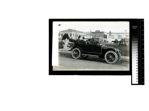 [Three men pose in an auto parked at the Arcata Plaza]