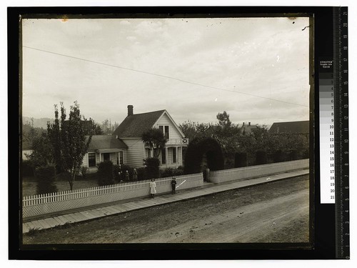 [Group posing in front of Ericson home]