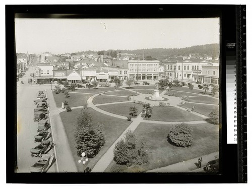 [Looking north over the Arcata Plaza with cars parked along H St.]