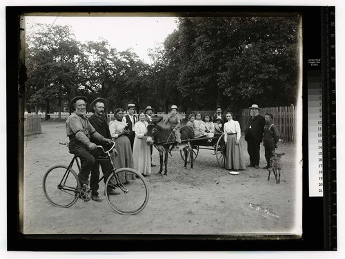 [Group of sixteen persons, a fawn, and a mule drawn cart]