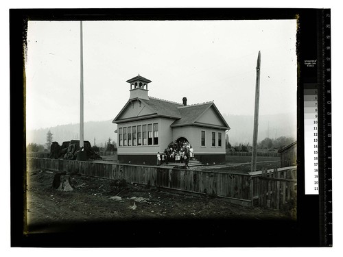 [Group of students & teacher on steps of rural school]