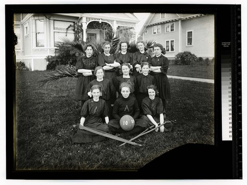 [Arcata High School girls in sport uniform with a ball and crutches]